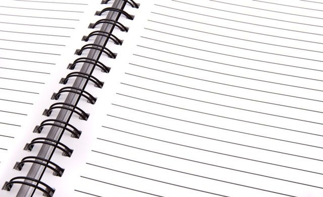 close up of open notepad with blank pages
