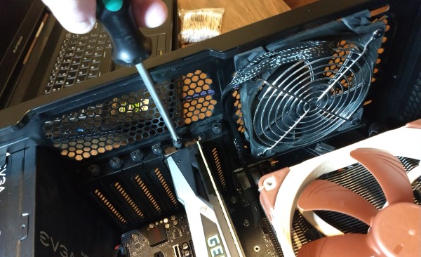 view of desktop computer tower being worked on, installing a video card