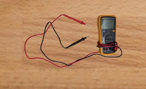 A multimeter showing negative and positive probes